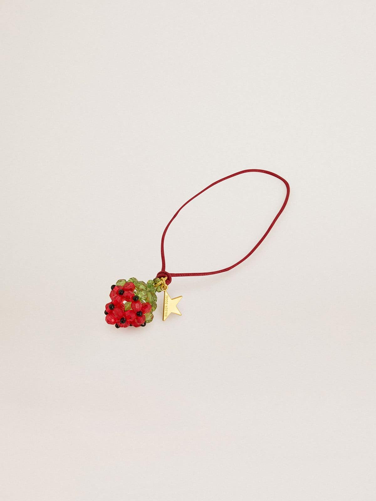 Red strawberry charm with gold star