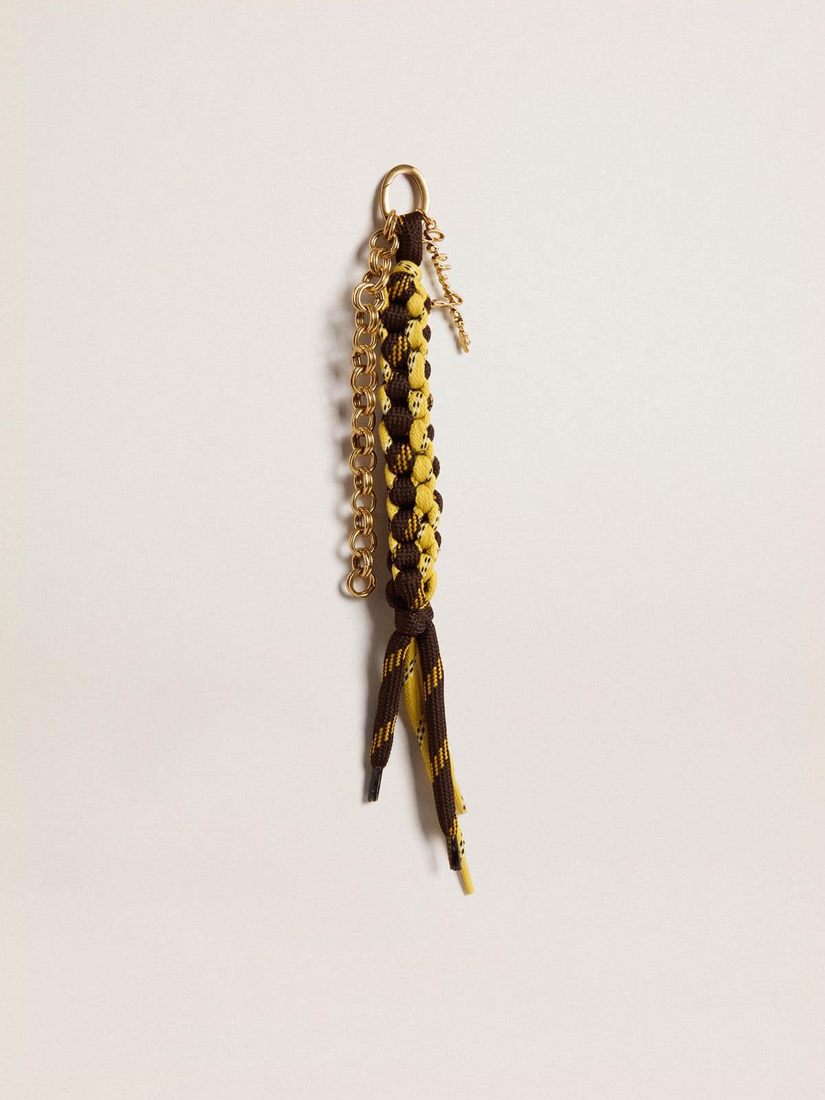 Charm with yellow and brown knotted hiking laces with chain
