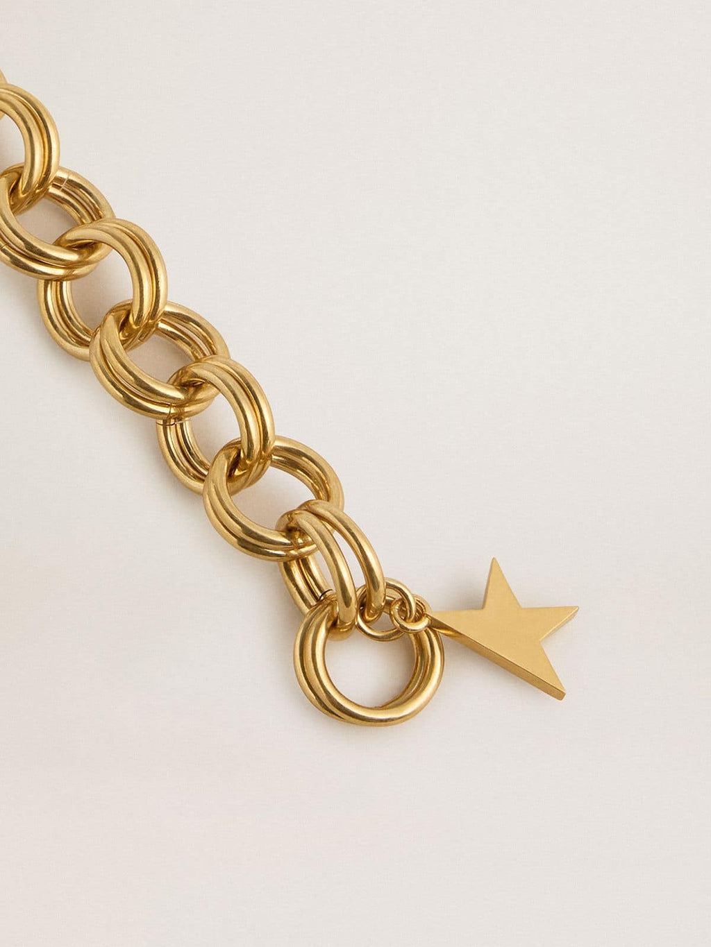 Antique gold-colored woven chain bracelet with star-shaped clasp