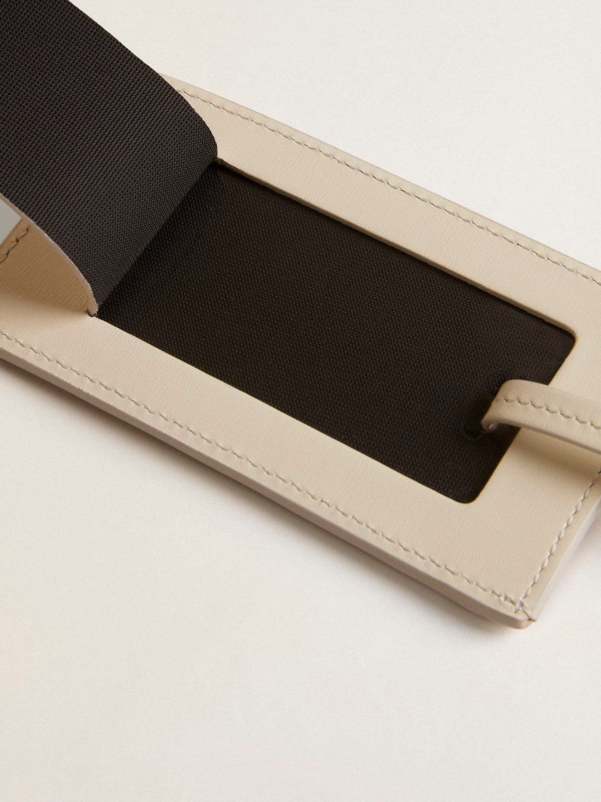 Worn white luggage tag