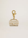 Purse-shaped charm in gold-colored brass with crystals