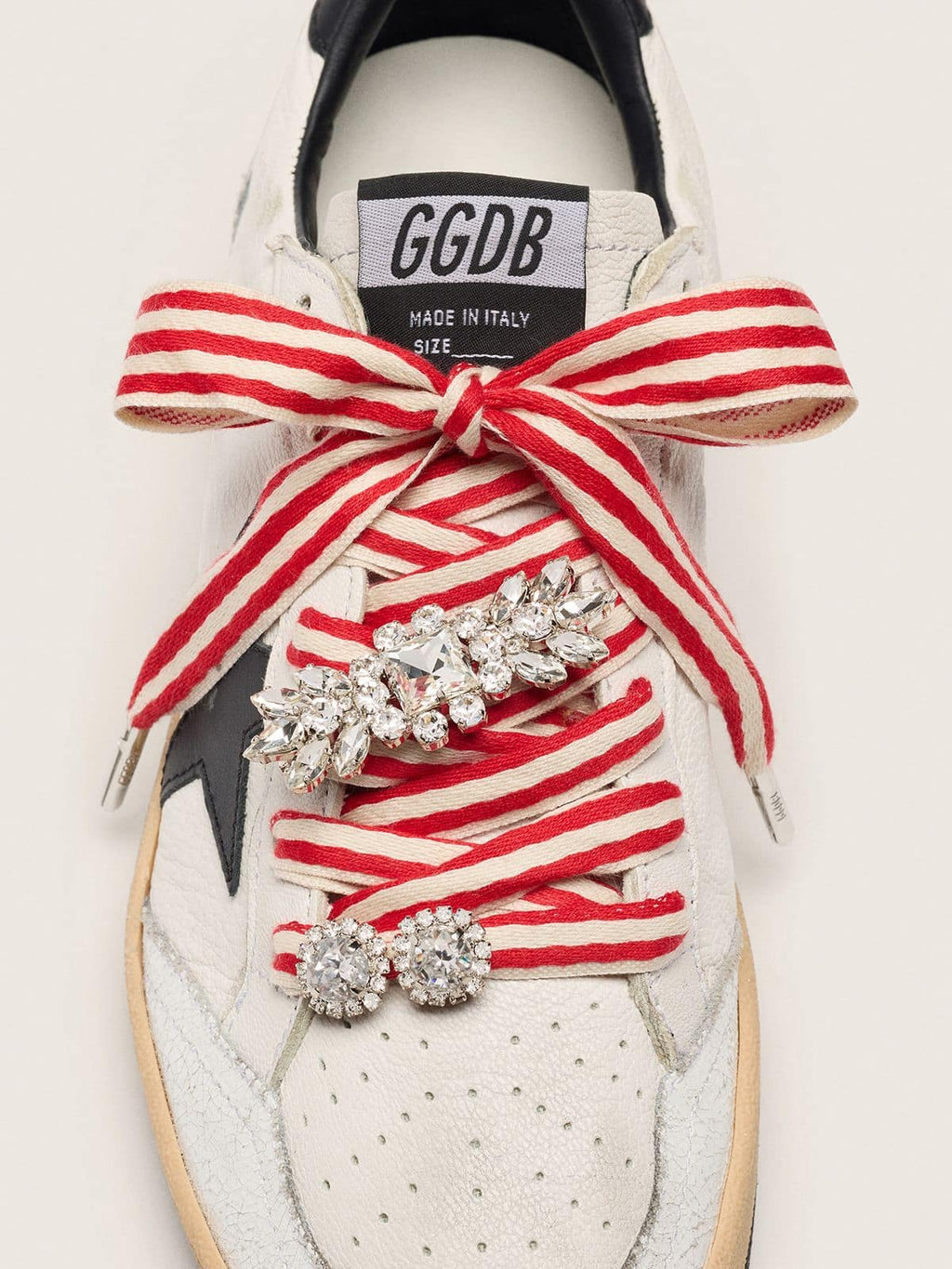 Skins "Playful" red and beige striped laces embellished with two charms