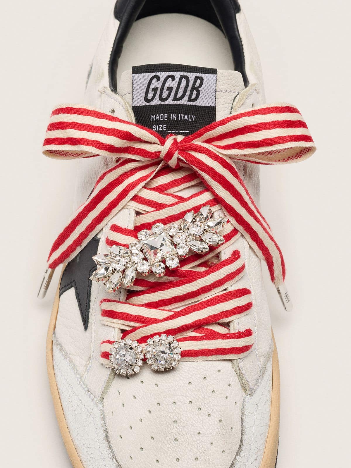 Skins "Playful" red and beige striped laces embellished with two charms