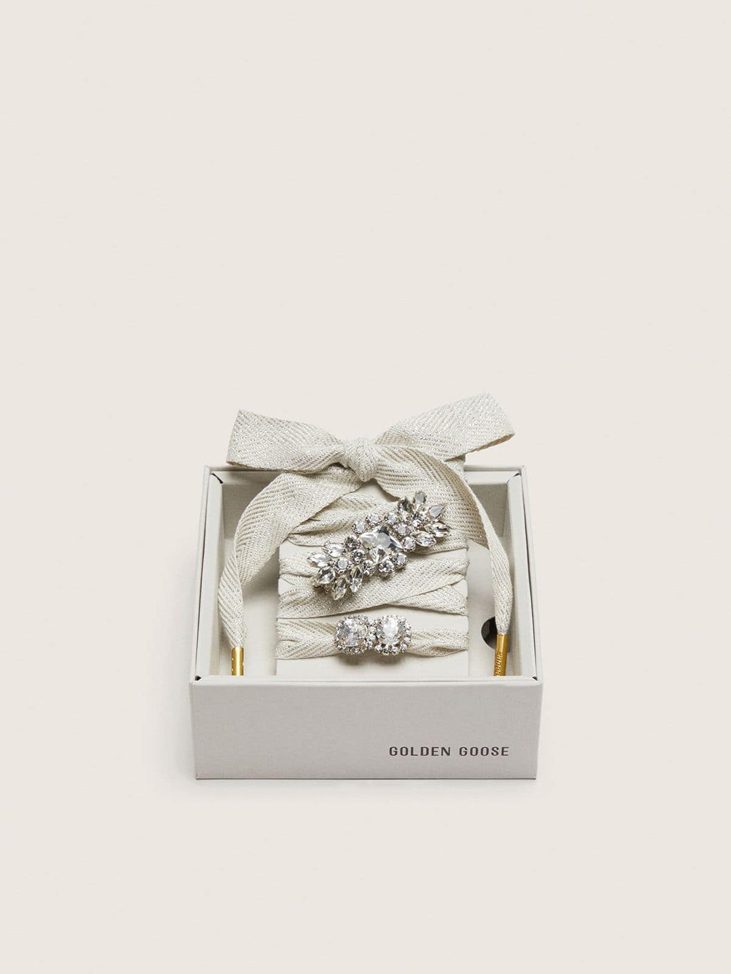 Skins "Sparkling" cream and silver herringbone laces embellished with two charms