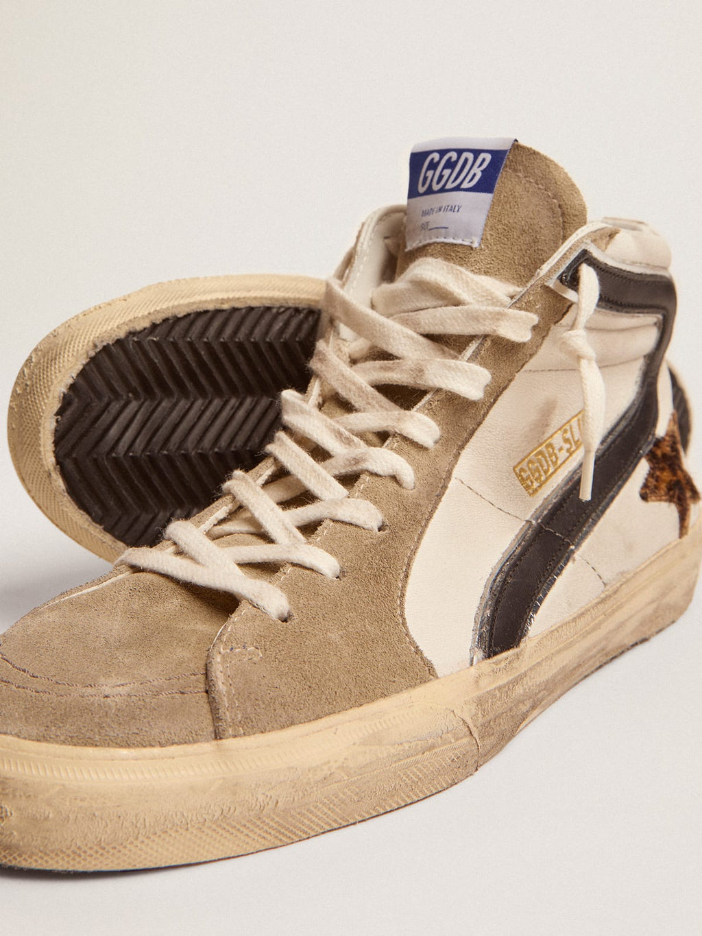 Sneaker Slide con stella in cavallino leopardato e virgola in pelle nera
