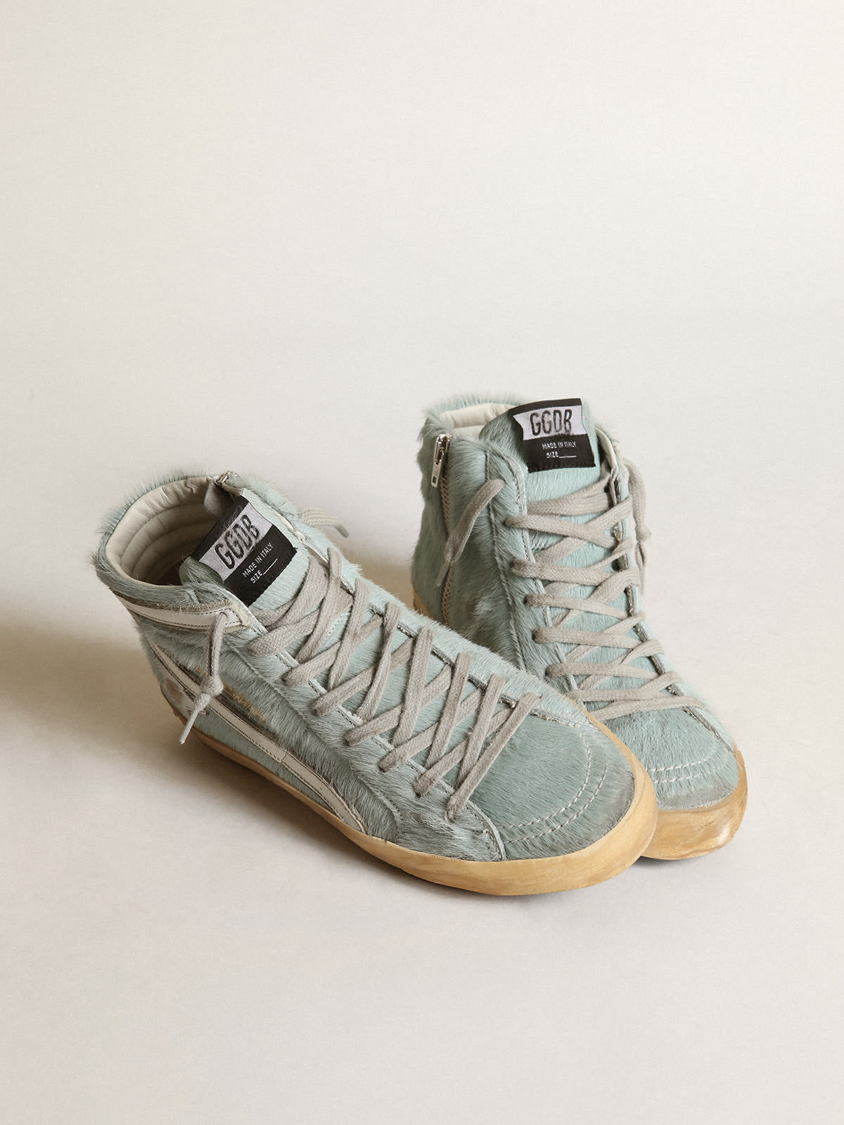 Sneaker Slide in cavallino color acquamarina con stella in pelle laminata color argento