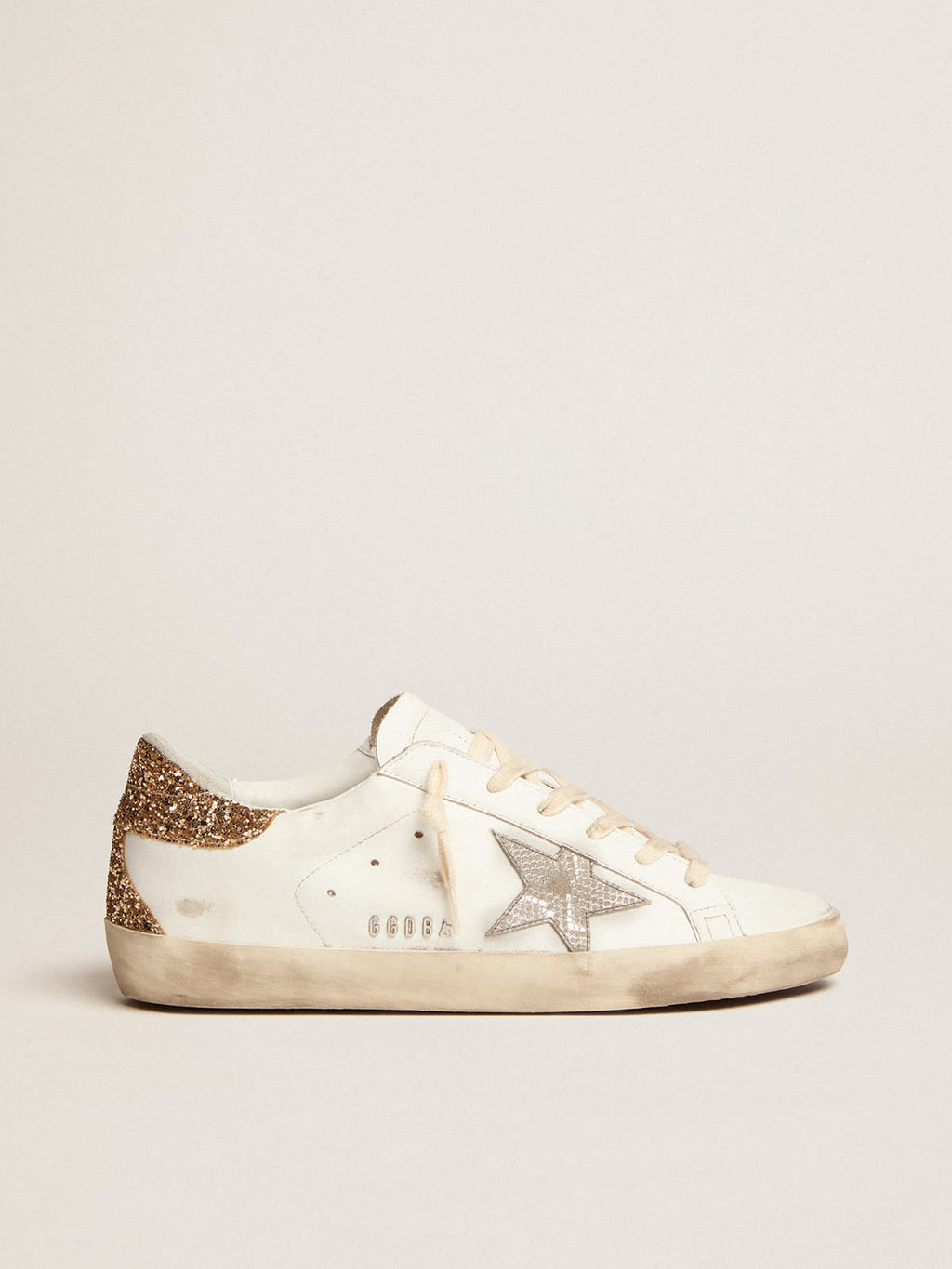 Sneaker Super-Star con stella in pelle color argento con stampa pitonata e talloncino in glitter dorati