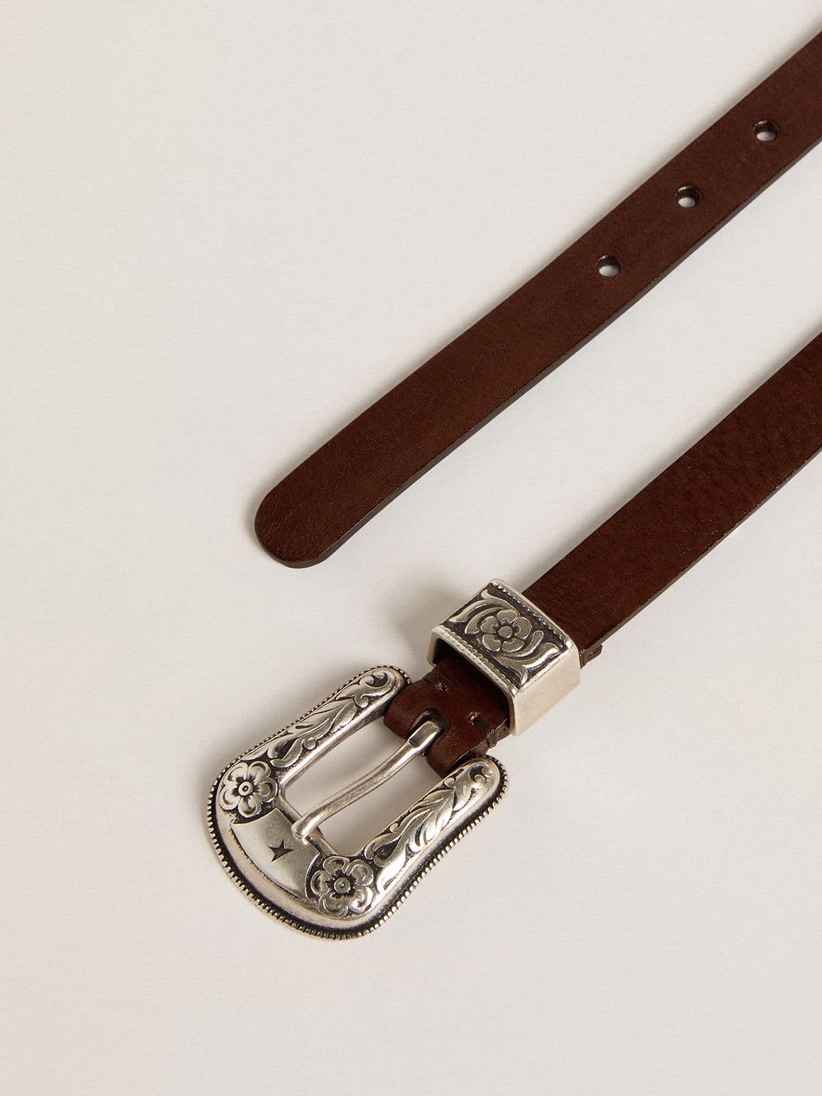 Women's dark brown leather belt with decorated silver buckle