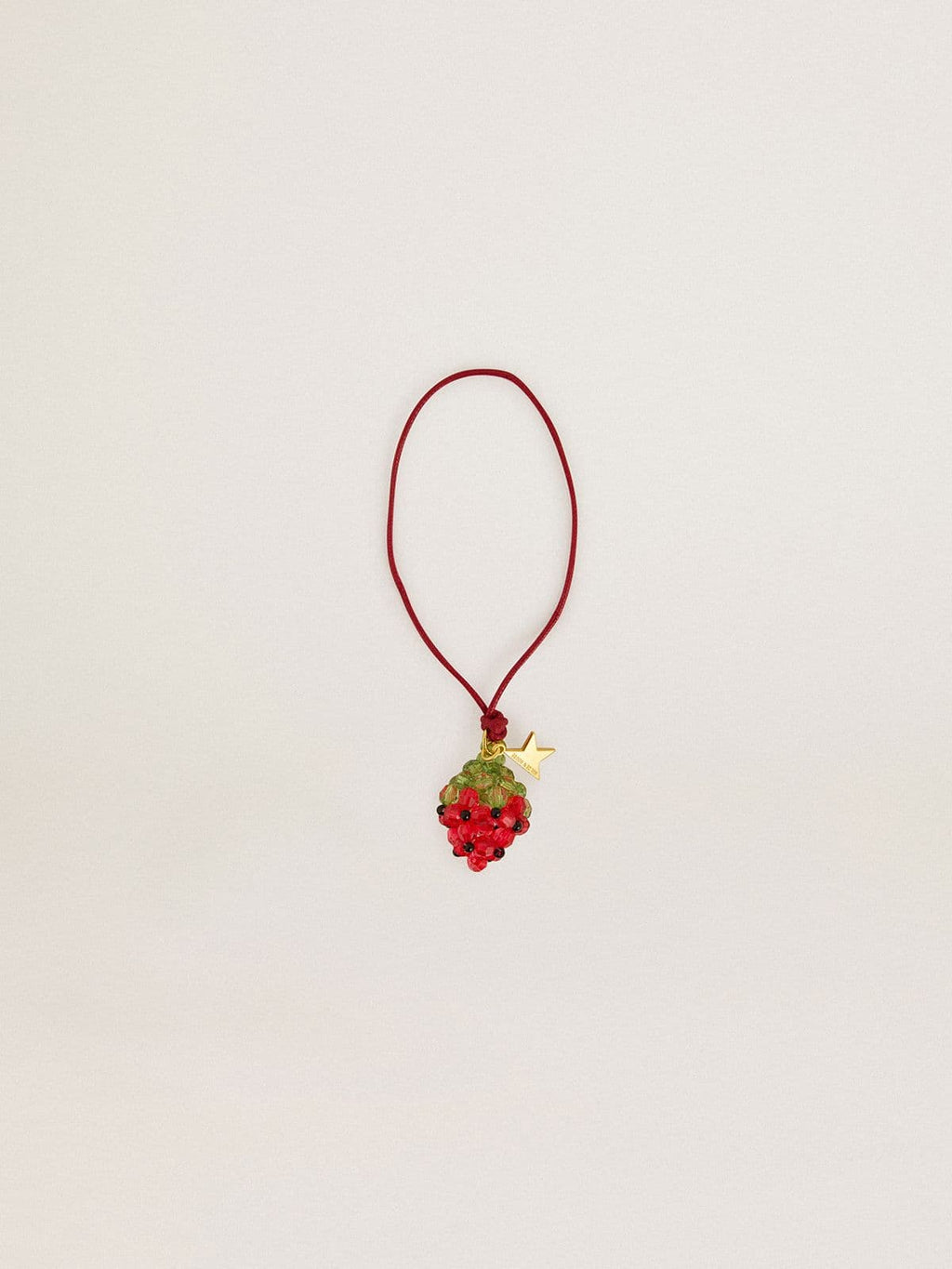 Red strawberry charm with gold star
