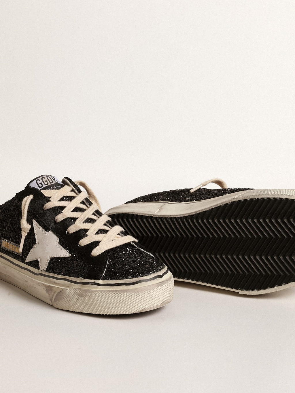 Super-Star Sabot in glitter neri con stella bio-based bianca