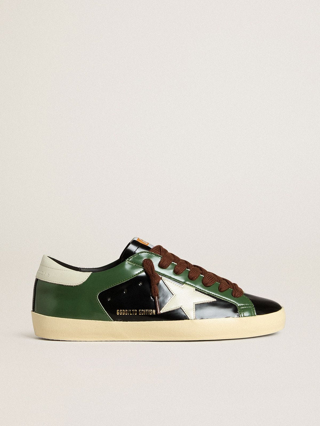 Men’s Super-Star LTD in black laminated leather with white leather star and heel tab