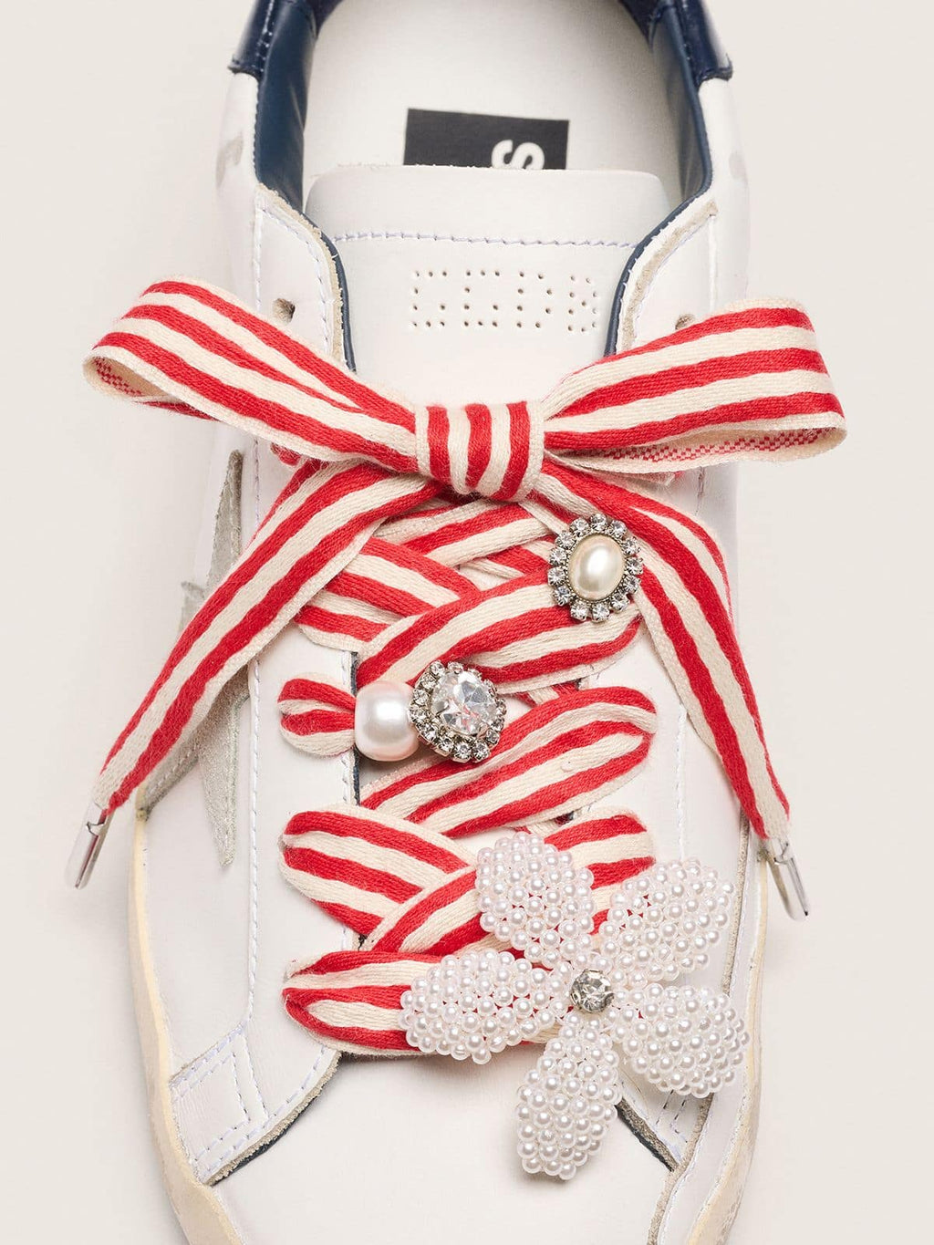 Skins "Playful" red and beige striped laces embellished with charms