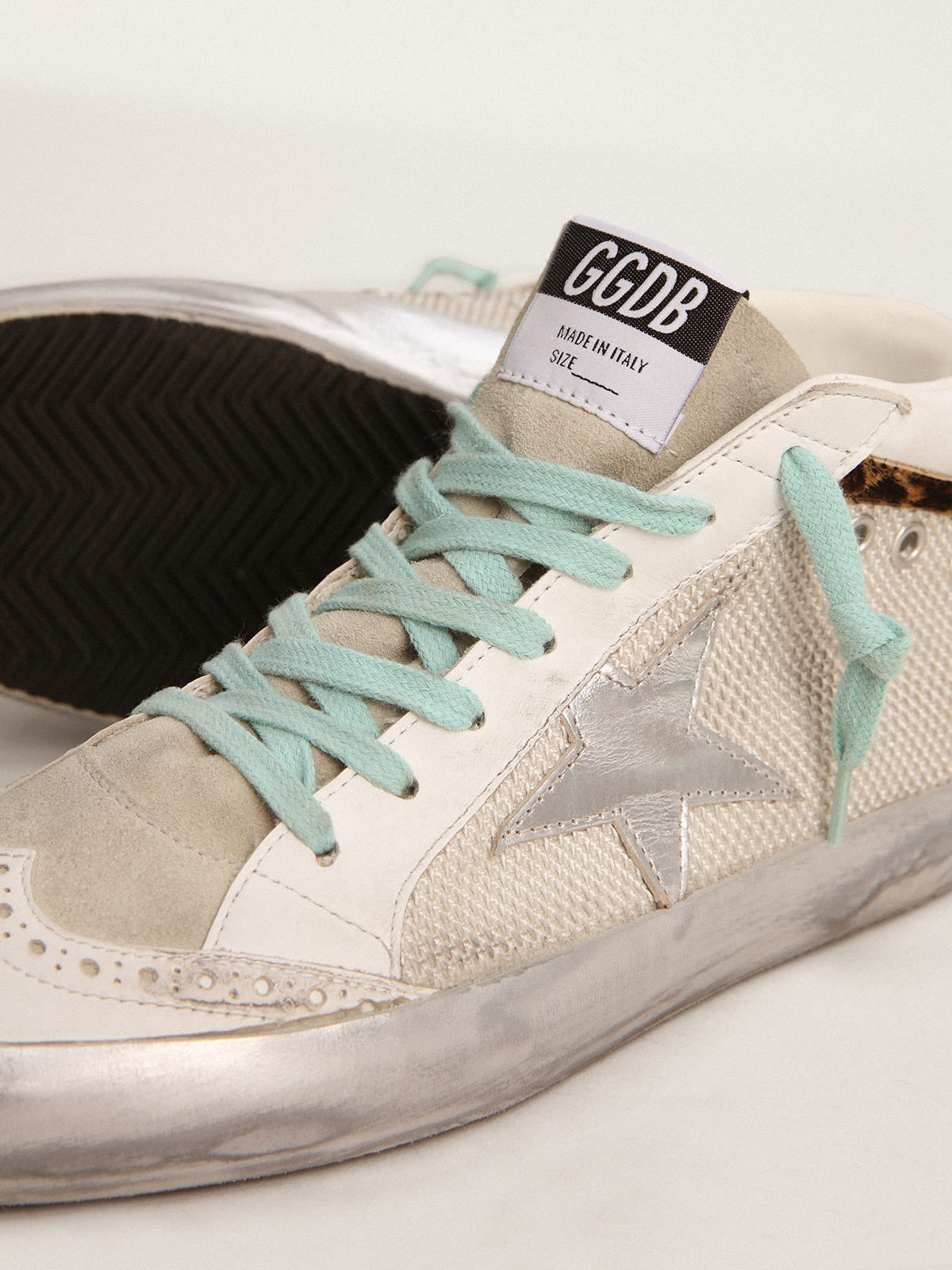 Sneaker Mid Star con stella in pelle laminata color argento e virgola in cavallino leopardato