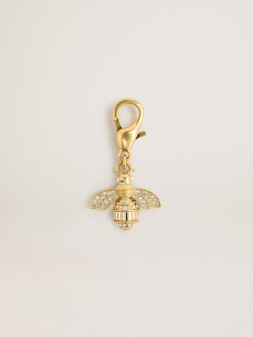 Bee-shaped charm in gold-colored brass with crystals